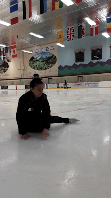 An ice skating coach demonstrates how to get up off the ice after falling.