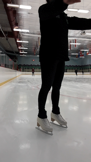 An ice skating coach demonstrates slow stopping on ice skates.