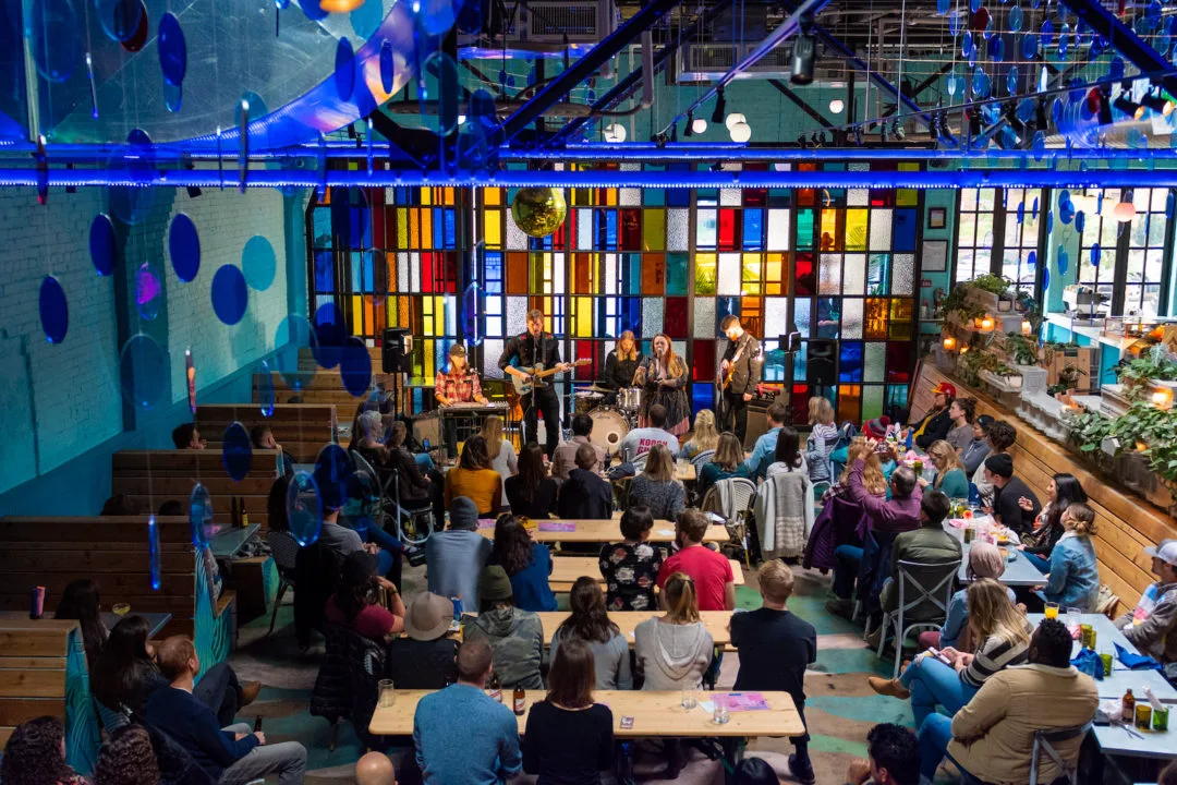 A crowd sits and watches a performance at Bang Up To The Elephant