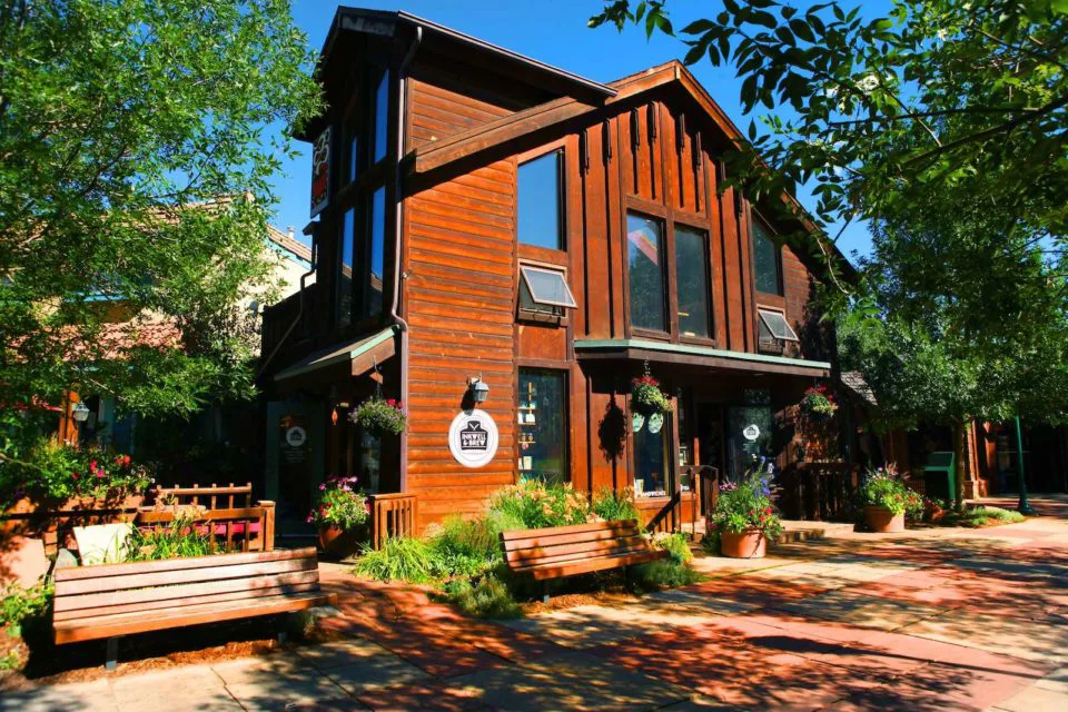 The exterior of Estes Park paper shop Inkwell & Brew, which is built in an alpine cabin style.