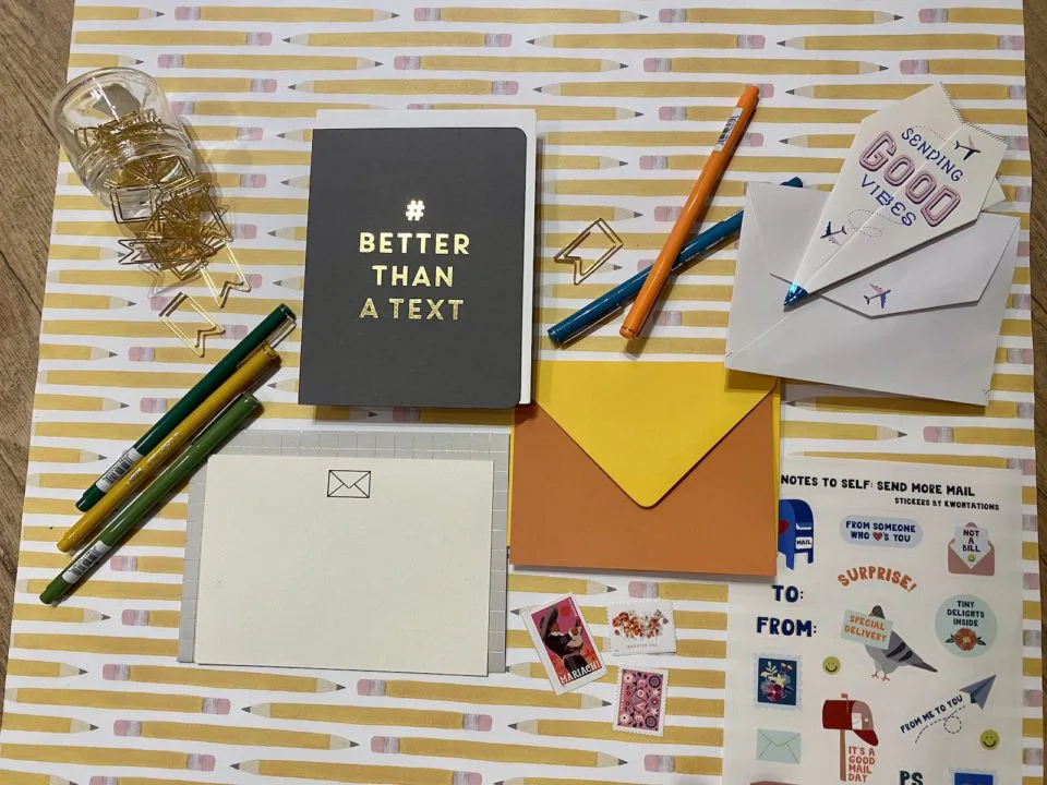 A card, envelope, pens, and stamps from paper shop Wordshop Paperie 