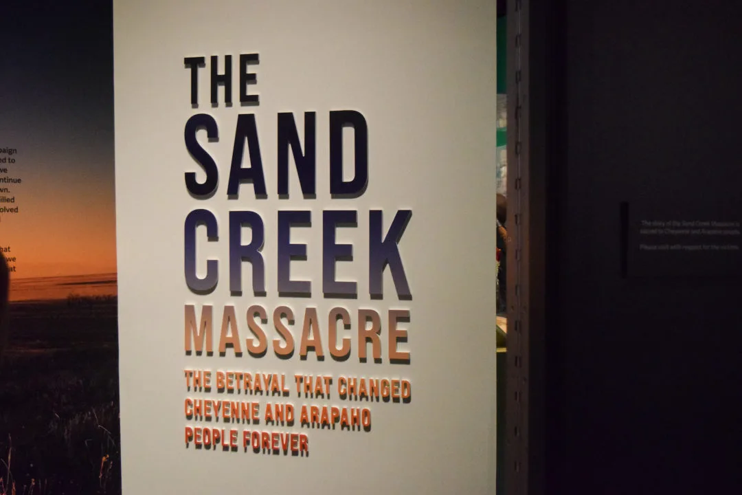 A photo of a sign displayed at the Sand Creek Massacre exhibit at History Colorado Center that reads "The Sand Creek Massacre.". Photo by Barbara Urzua