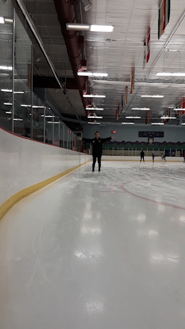 An ice skating coach demonstrates how to march and glide on ice skates.