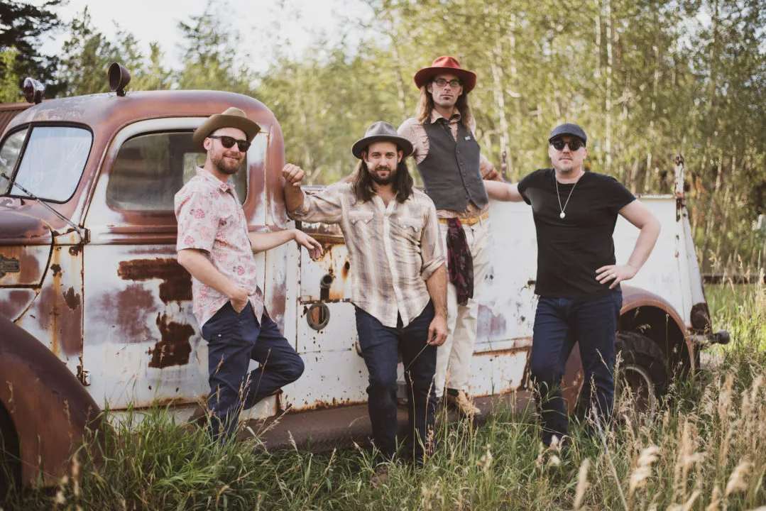 A photo of the band David Lawrence and the Spoonful in front of a truck. Photo by Roxie Photo