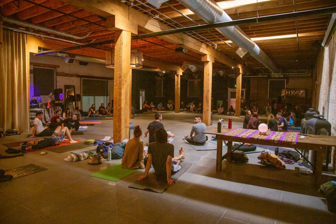 People gather on yoga mats for one of Habitual Roots' events
