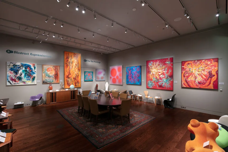 The interior of the Kirkland Institute featuring chairs, furniture, and Vance Kirkland's abstract paintings