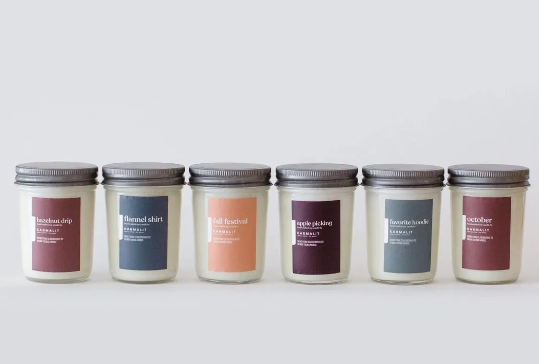 Six fall-themed soy candles in glass jars