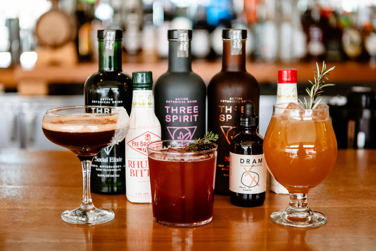 Three mocktails sit on a bar